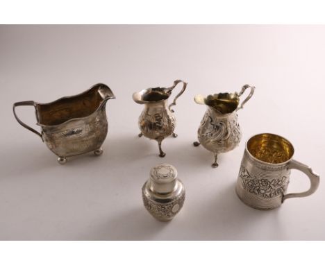 A MIXED LOT OF SILVER:- A George III Irish cream jug on ball feet, initialled, a Victorian embossed cream jug on three legs, 