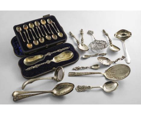 A MIXED LOT:- A Dutch sugar sifter ladle, a Dutch caddy spoon, three large and two small Continental cast spoons, a cast &amp