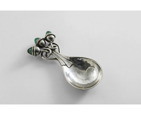 AN EARLY 20TH CENTURY HANDMADE CADDY SPOON with a hammered, drop-shaped bowl and a tendril handle terminating in three caboch