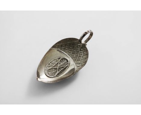 A GEORGE III CADDY SPOON with an acorn shaped bowl with an inset filigree panel, stamped "hatching" and a ring handle, by Sam