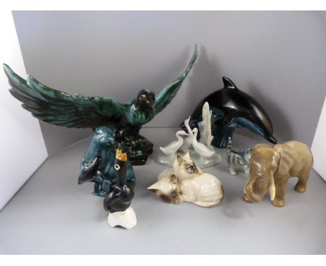 A quantity of animal figures to include a Sylvac Elephant, Poole Pottery Dolphin and Otter, Royal Doulton figure group of two
