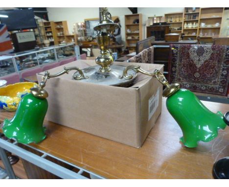 A Brass hanging centre light with green glass shades