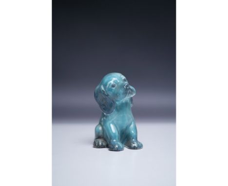 A delightful Beswick blue glazed ceramic figurine of a sitting dog, marked 2730 on the base. Measuring 4.5"H, this piece feat