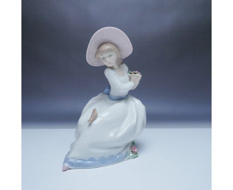 Beautiful Nao by Lladro porcelain figurine titled The Nightingales Song, model number 1345. This elegant piece features a you