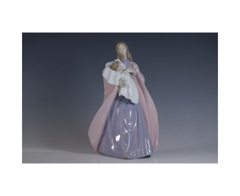 Nao by Lladro porcelain figurine titled A Mothers Touch, model 1300. This elegant piece depicts a mother tenderly cradling he
