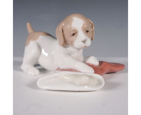 Nao by Lladro Puppy with Stocking figurine, model number 1427, a charming porcelain sculpture capturing the playful innocence