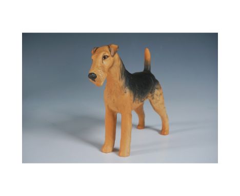 This is a charming ceramic figurine of an Airedale Terrier named CH Cast Iron Monarch, produced by Beswick, England. The figu