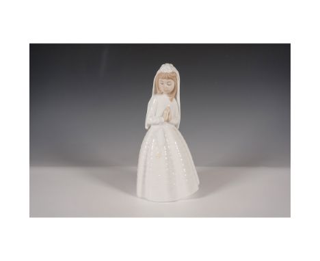 A finely crafted Nao by Lladro porcelain figurine titled Girl Praying, depicting a young girl in a white communion gown with 