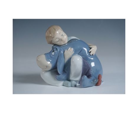 This delightful porcelain figurine features a young child embracing Eeyore, the beloved character from Disney's Winnie the Po