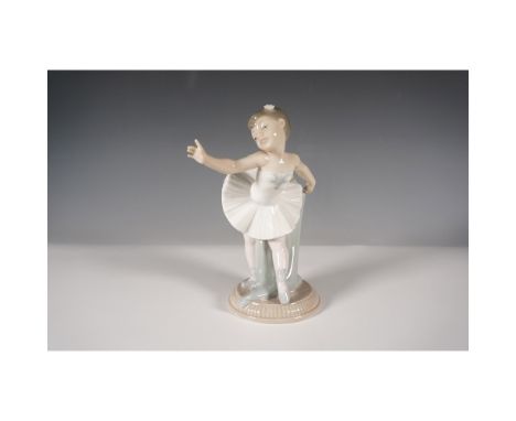 Charming Nao by Lladro porcelain figurine titled "My First Bow", featuring a young ballerina gracefully curtsying after her p