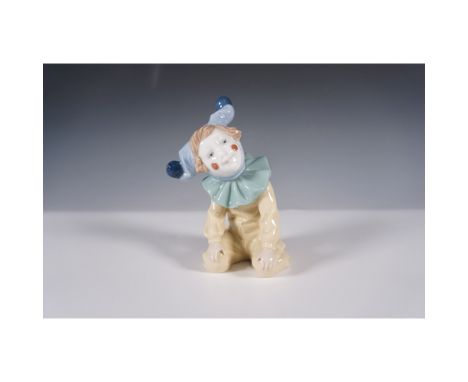 Charming NAO by Lladro porcelain figurine titled "Clown with Ruffled Collar," model number 01067. The piece depicts a seated 