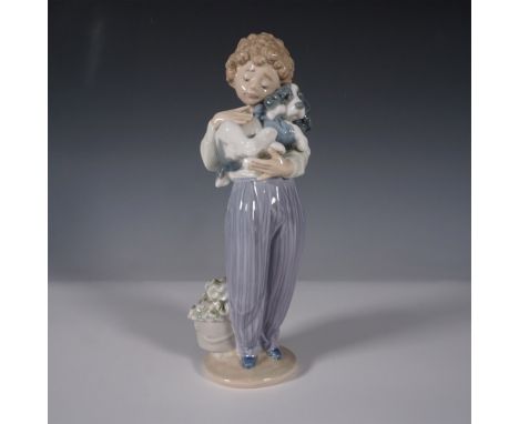 This Lladro porcelain figurine titled My Buddy (1007609) captures the endearing bond between a young boy and his playful dog.