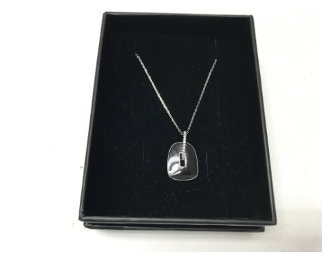A 14ct white gold necklace with a black enamel pendant. Approx weight 3.14 grams. Shipping category A.