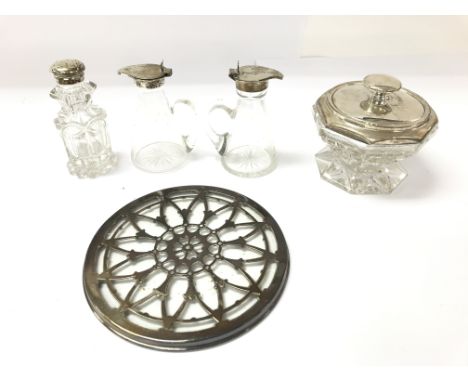 A collection of silver and glass items including whiskey tot a pepper pot 1865 a powder bowel 1922 and a silver teapot stand.