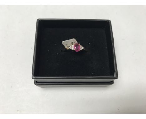 A 14ct gold diamond and Ruby set ring. Approx weight 1.92 grams, approx 12pts. Size N. Shipping category A.