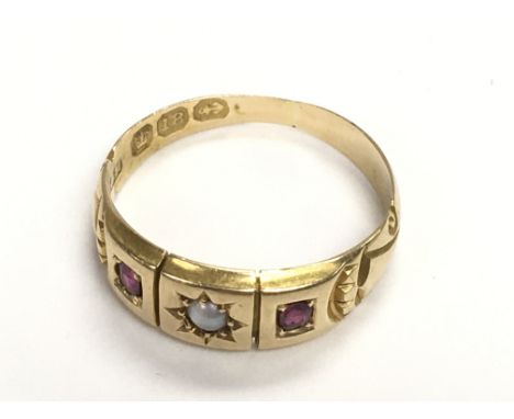 18ct yellow gold three stone ruby and pearl dress ring, with two oval cut ruby stones and one round pearl in the centre of th