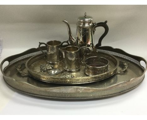 A collection of silver plated items comprising a galleried tray, a three piece tea service, spirit labels and other items. Sh