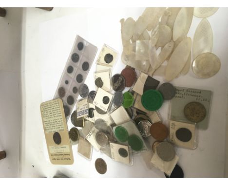 A collection of mother of pearl Chinese gaming tokens Roman coins and other coins..
