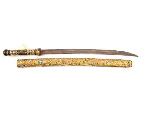 A bazaar quality dha,  curved blade 17”, the hilt and scabbard covered with thin gilt sheet metal embossed with scrolled pane
