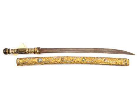 A bazaar quality dha,  curved blade 17”, the hilt and scabbard covered with thin gilt sheet metal embossed with scrolled pane