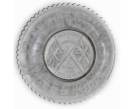 A commemorative glass plate  beaded inscription “Baden Powell” and Mafeking around the rim, in the centre a stand of flags an