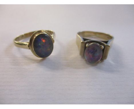 A 9ct yellow gold and black doublet opal ring, and another 9ct yellow gold and opal triplet ringLocation: 