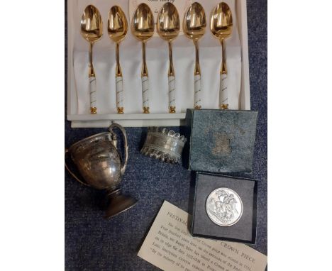 A 1920's silver trophy with twin handles (several dents) 53.7g together with a silver napkin ring 21.2g and a set of six mode