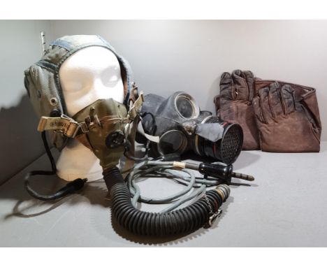 An RAF flying helmet, blue cloth with leather integral head phones and rubber mask, together with a WWII British military iss