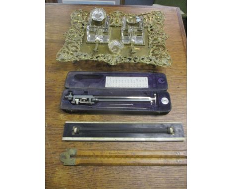 A Victorian brass desk ink stand with two cut glass inkwells, a J Wilkinson inventor folding wood and brass ruler, a slide ru