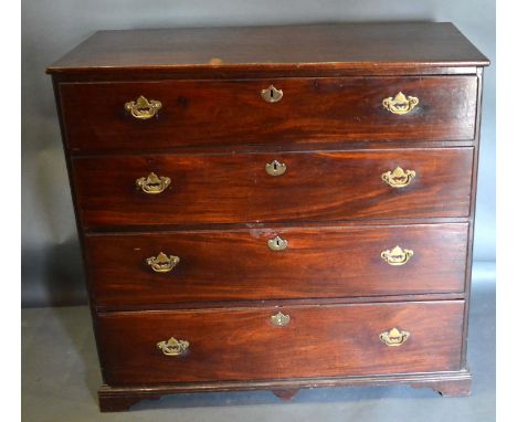 A 19th Century Mahogany Straight Front Chest Of Four Long Drawers with brass handles and escutcheons, raised upon bracket fee