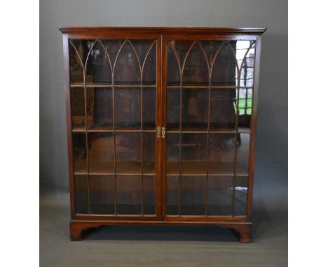 A 19th Century Mahogany Bookcase The Moulded Cornice above two arched glazed doors enclosing shelves, raised upon bracket fee
