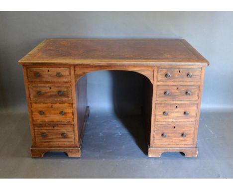 A 19th Century Mahogany and Crossbanded Twin Pedestal Desk, the tooled leather inset top above eight drawers with brass knob 