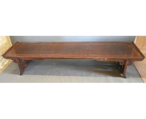 A Late 19th Early 20th Century Chinese Hardwood Low Table, the shaped scroll top above twin end pierced supports, 216 cms wid