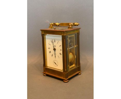 A French Brass Cased Carriage Clock retailed by Dent, London, the enamel dial with Roman numerals and subsidiary alarms dial 