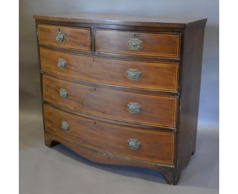 A 19th Century Mahogany And Inlaid Bow Fronted Chest of two short and three long drawers with brass handles, raised upon brac