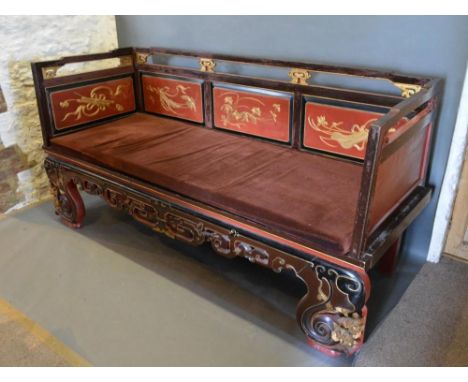 A Late 19th Early 20th Century Chinese Lacquered Day Bed, the pierced back above a panel seat and similar frieze raised upon 