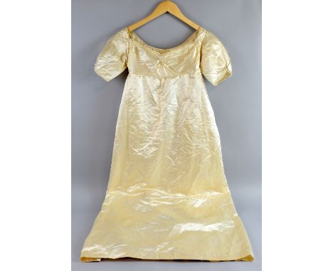 Late Georgian or Regency cream silk wedding dress, with empire line and puffed sleeves .  Good condition with light staining 