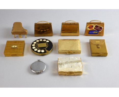 A collection of novelty powder compacts, including examples in the form of luggage items (2 of which musical) , a pocket watc