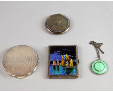 Four powder compacts in white metal, one of a harbour scene with butterfly wing decoration, another depicting a man on horseb