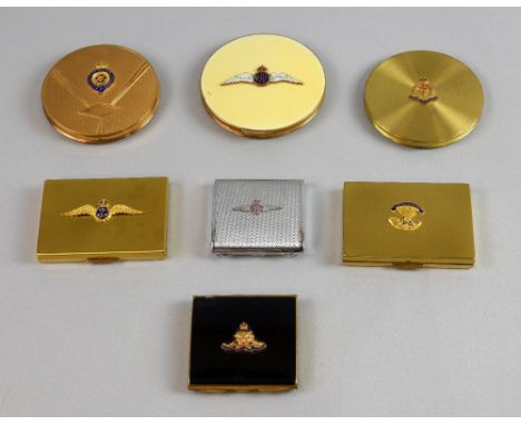 A collection of compacts with enamelled insignia relating to the Armed Forces in a variety of shapes and finishes including R