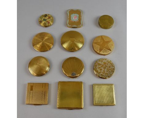 A mixed group of powder compacts in gilt metal with engraved and enamel lids, including examples by Darling, Talent, Pygmalio
