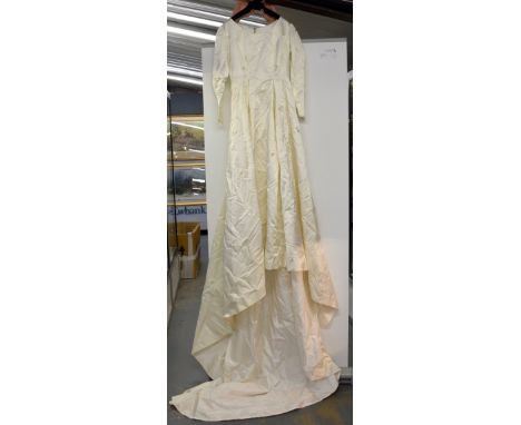 A vintage wedding dress with boat neck  full train, made in Swiss satin with flowers in silk stitch, mid 20th C  .  Overall g