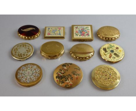 A collection of gilt metal English powder compacts by Kigu, Flamingo and Rimmel, with lids in a range of  decorative finishes