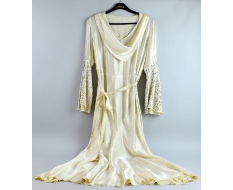 1929 ivory satin wedding dress together with a 1930's long black shot taffeta dress with peplum .  Both items in wearable con