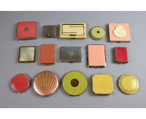 A collection of Art Deco powder compacts in pastel shades with typical geometric designs, including one with a Pierrot head, 