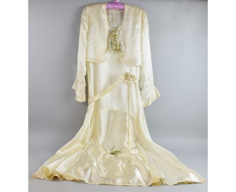 Ivory satin long sleeved wedding dress (1932) with wax orange blossom and heather accessory.  Good condition with light mottl