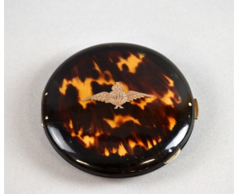 A tortoiseshell powder compact with inlaid gold RAF insignia on front andBerly on reverse.  