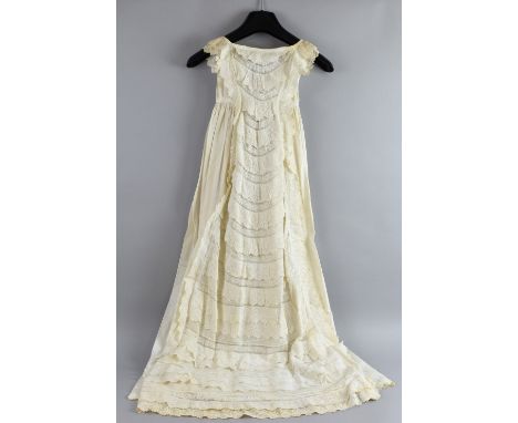 Two Victorian christening gowns with extensively embroidered tiered frills on front panels .  First gown has small, minor are