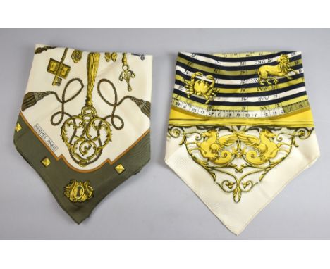 A pair of Hermes silk scarves in the Key and Dies et Hore (signs of the zodiac patterns) approximately 90 cm square.  Both sc