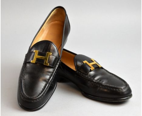 A pair of classic Hermes lady's  loafers on black leather with H buckles size 38 1/2.  